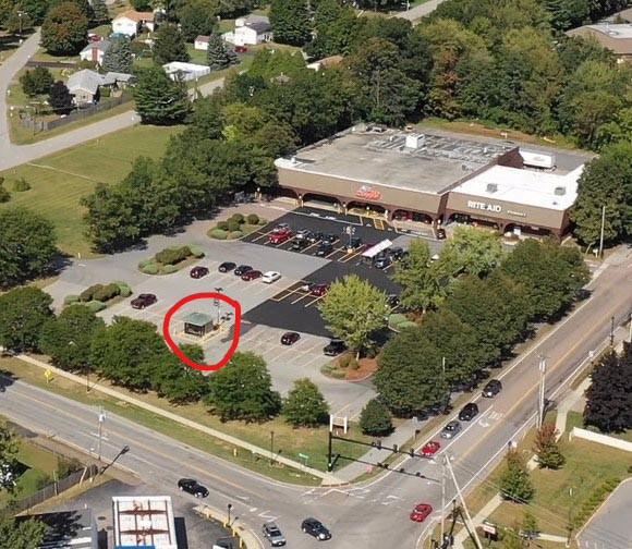 Aerial view of stand-alone ATM building in shopping plaza parking lot Colchester, Vermont