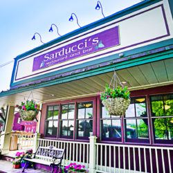 Restaurant with Sarducci's sign and hanging flower baskets