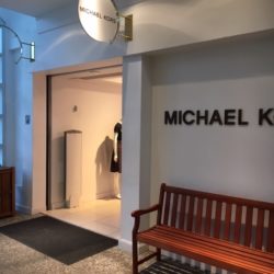 Sign that reads Michael Kors with bench underneath, Manchester, VT retail outlets